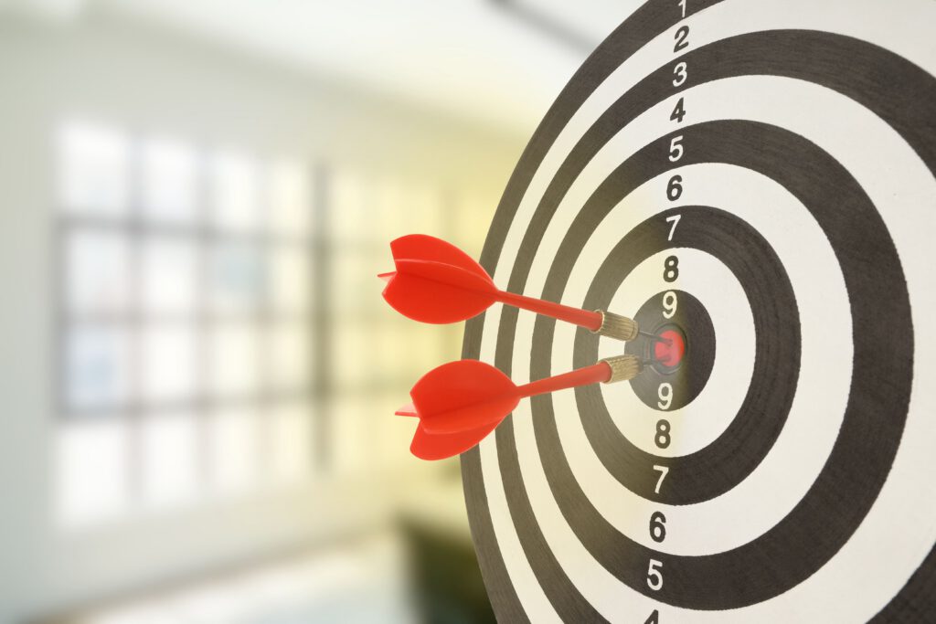Target bullseye with darts hitting center - results-focused dental marketing strategy