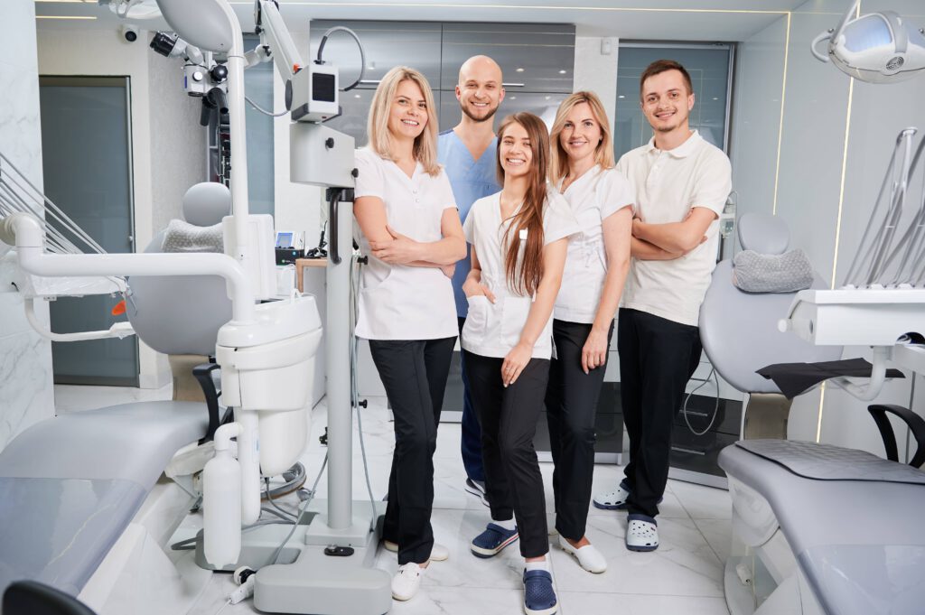 Professional dental team portrait in modern clinic